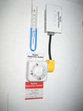 Load image into Gallery viewer, Radon Reduction System Instrumentation and table lamp timer set to prevent high indoor relative humidity The blue oil-filled u-tube will show oil rising on one leg when teh fan is operating.. But there is a very serious problem. When the filter is clogged, teh oil will rise even higher indicating that the system is operating at maximum performance level when in fact, the filter is blocked and no air is flowing, and radon has risen to pre-mitigation levels..